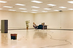 photo of lonely office worker in huge, empty office space